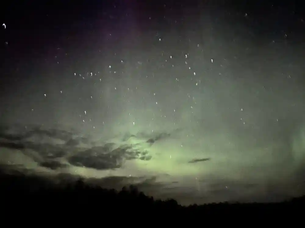 Aurora borealis with stars and clouds at twilight